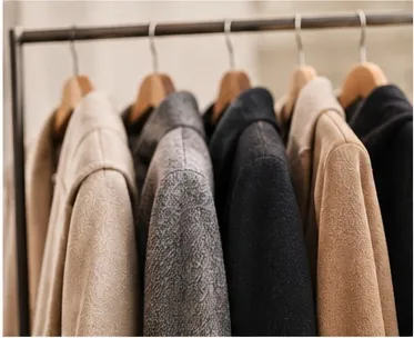 Fur-free coats in wool, bouclé and knit on a clothing rail