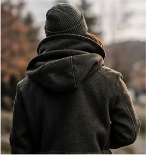 Person seen from behind in a hooded fur-free coat